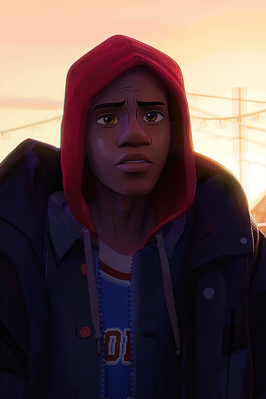 Miles Morales wearing a red hoodie and black jacket looks thoughtfully off-camera during a warm city sunset.