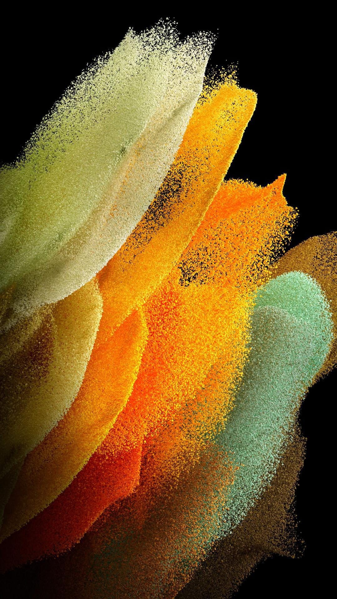 Neon green, orange, and red powder particles swirl in a dense cloud against a deep black backdrop.