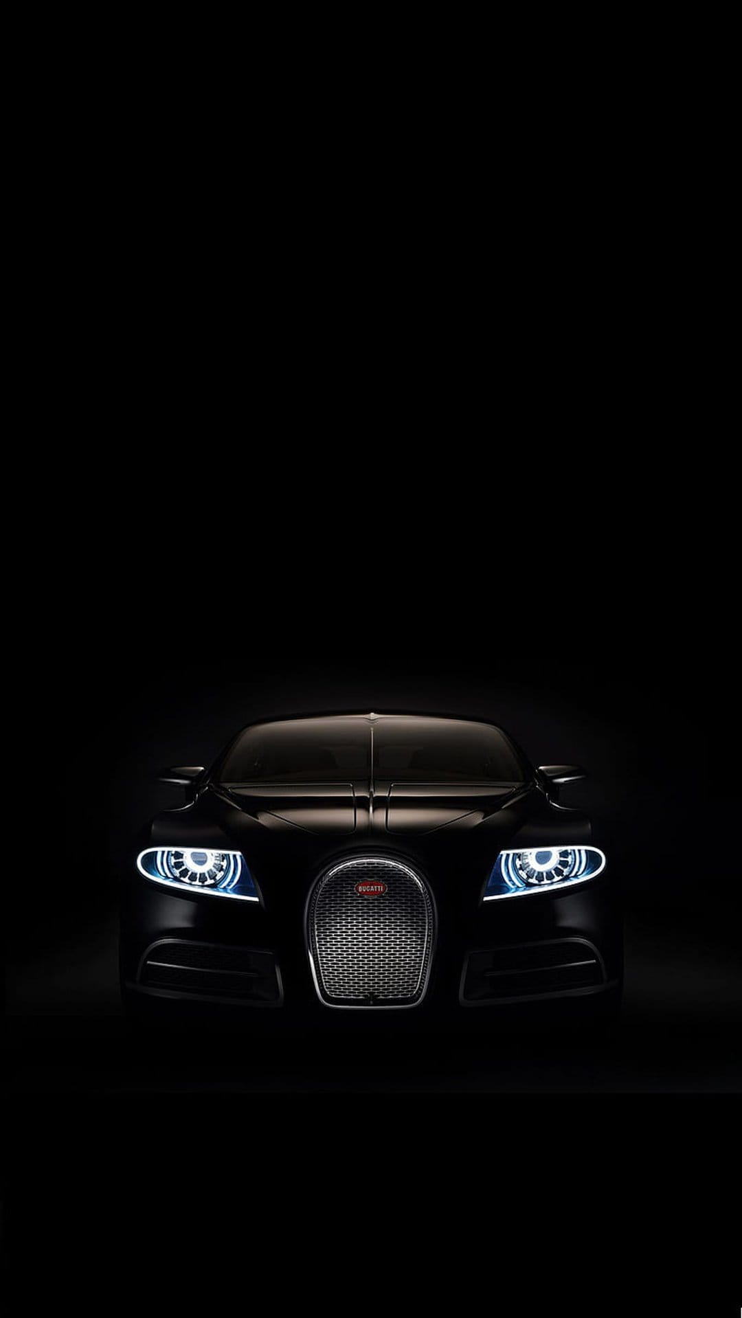 Black Bugatti Veyron with illuminated quad headlights and horseshoe grille centered against a dark background.