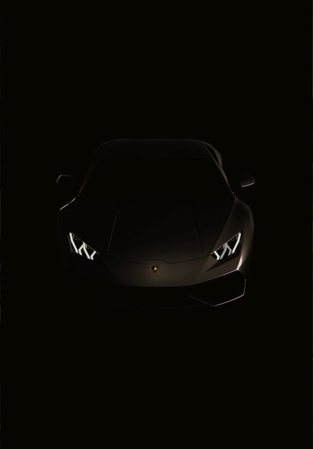 Lamborghini Huracan headlights glowing in the dark with sharp LED signatures and a subtle hood emblem visible.