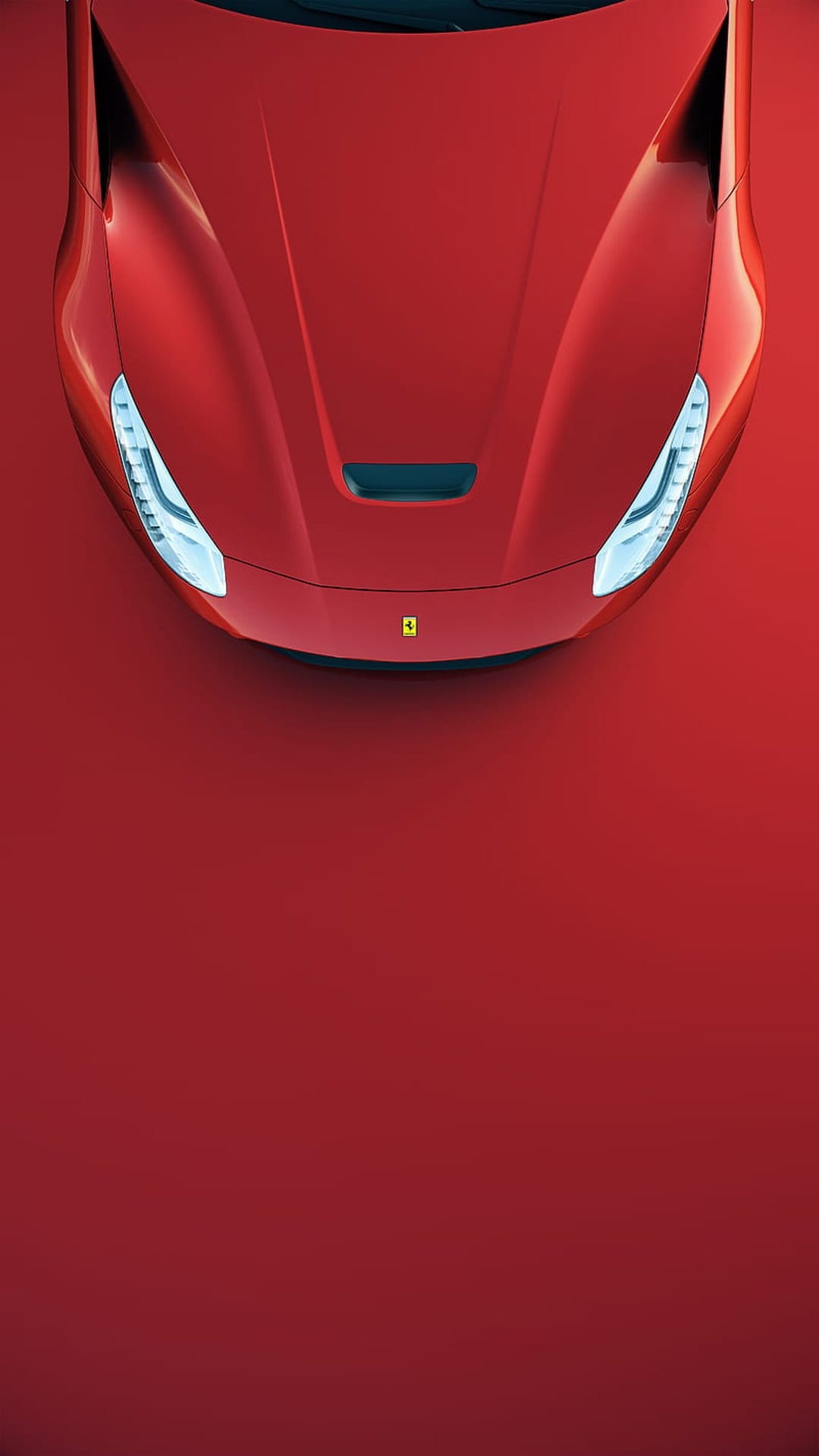 Red Ferrari hood and intricate LED headlights viewed from above, showcasing glossy paint and aerodynamic curves.