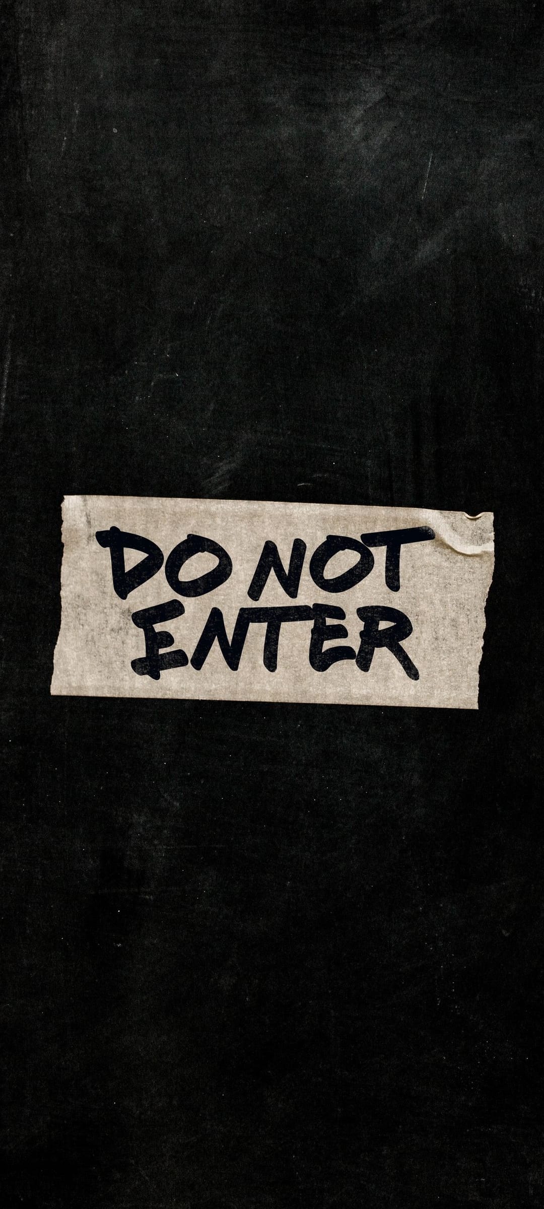 Do Not Enter sign handwritten on white tape centered on a dark textured black background with gritty details.