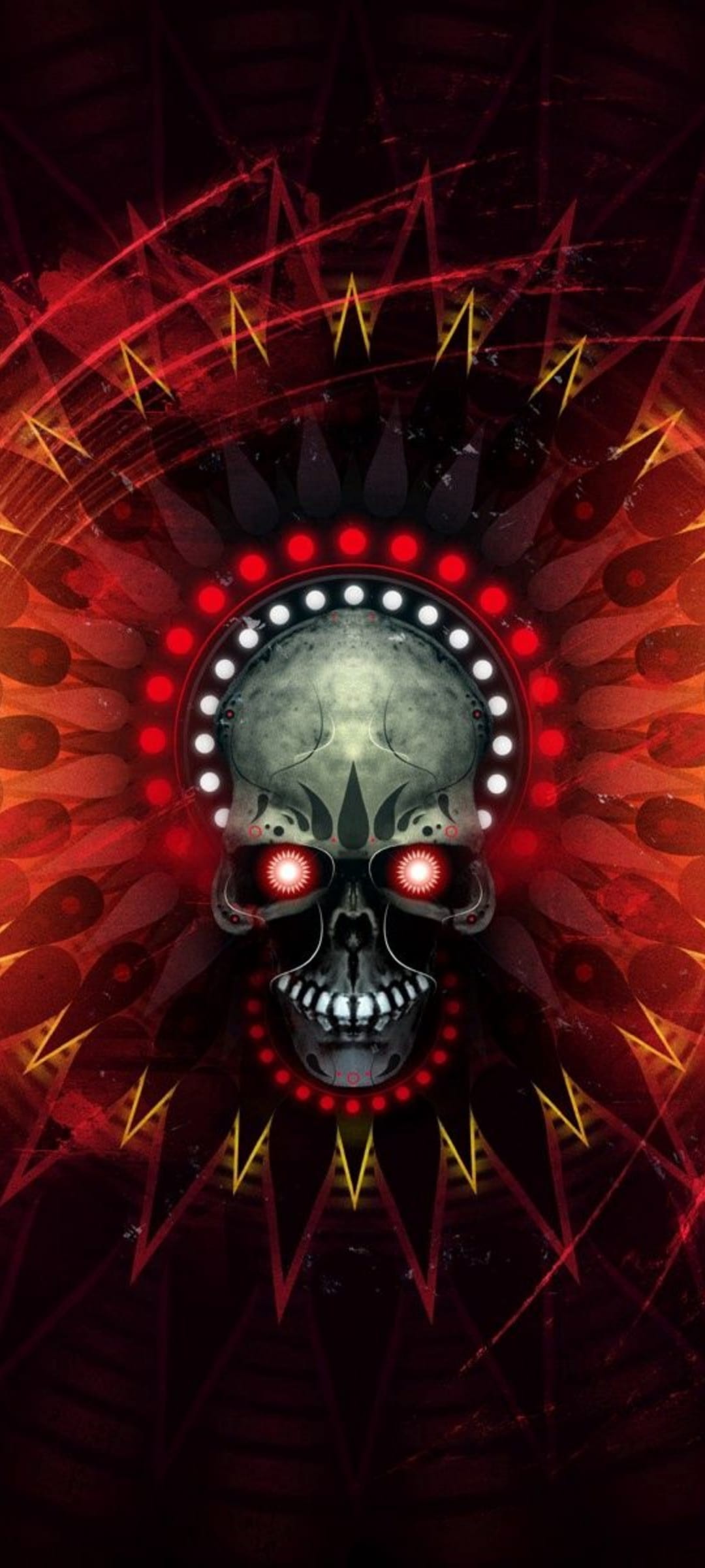 Skull with glowing red eyes wearing an orb headdress against a radiant sunburst of orange and yellow rays.
