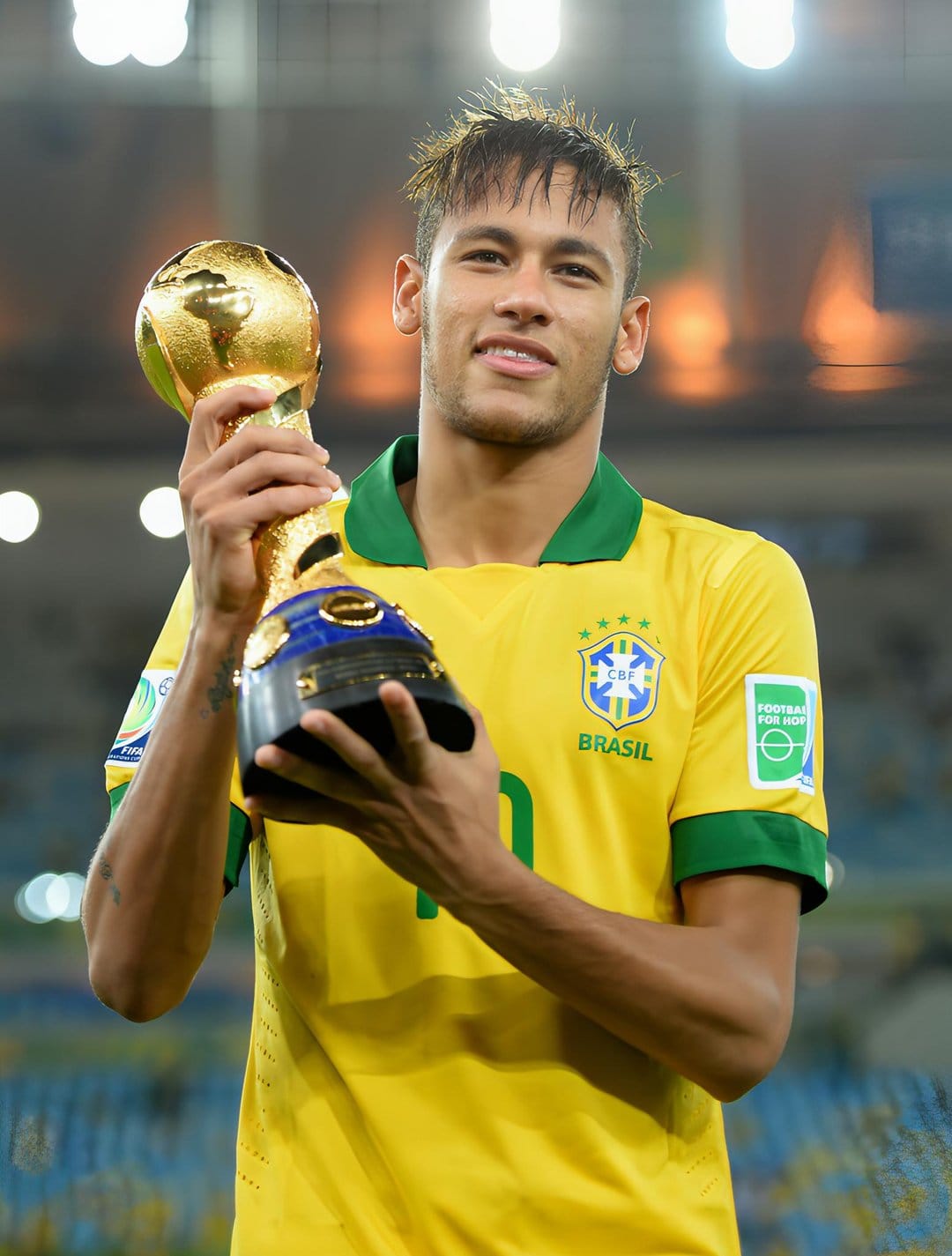 Neymar Jr. lifts a golden globe trophy while wearing a yellow Brazil football jersey during a victory moment.