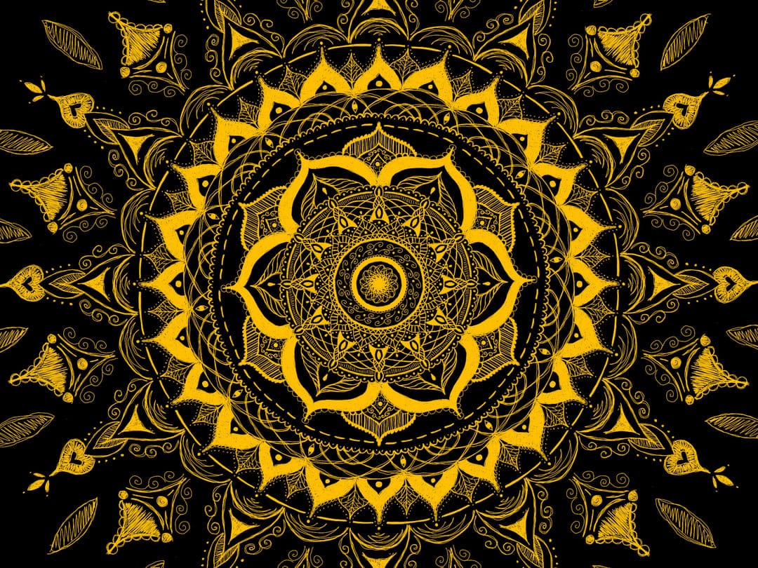Golden sun mandala with symmetrical floral patterns and intricate line work on a dark black background.