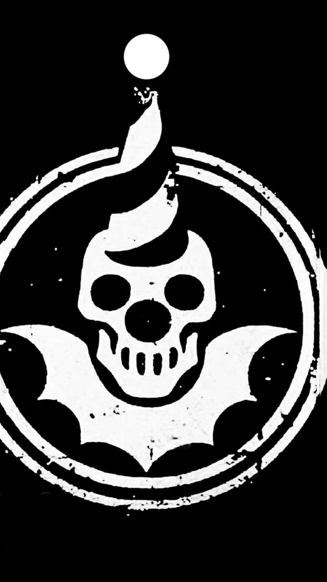Grinning jester skull with a three-pointed hat inside a weathered black circular border on a white background.