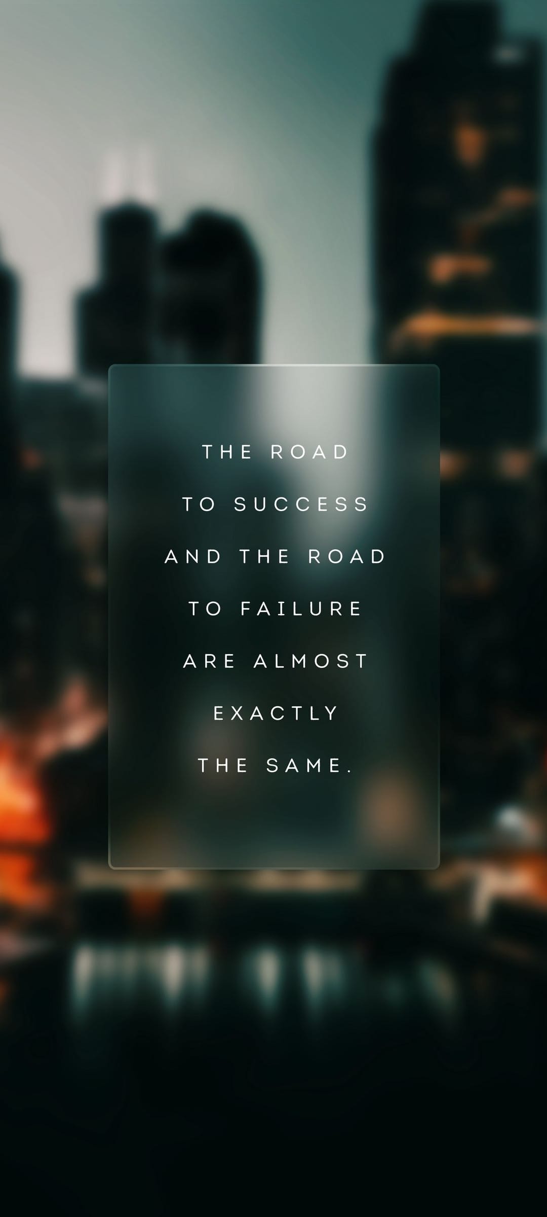 White motivational text about success and failure centered over a blurred urban skyline at twilight.