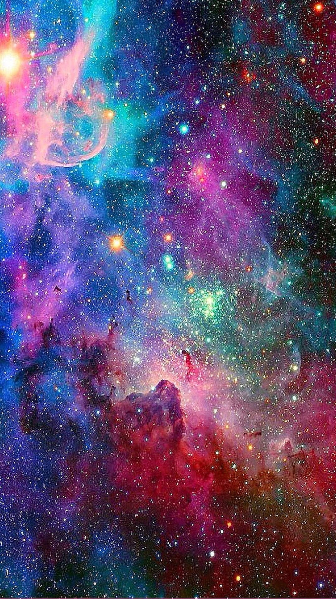 Swirling pink and purple gas clouds of a vibrant nebula surround tiny glowing stars in a deep space scene.