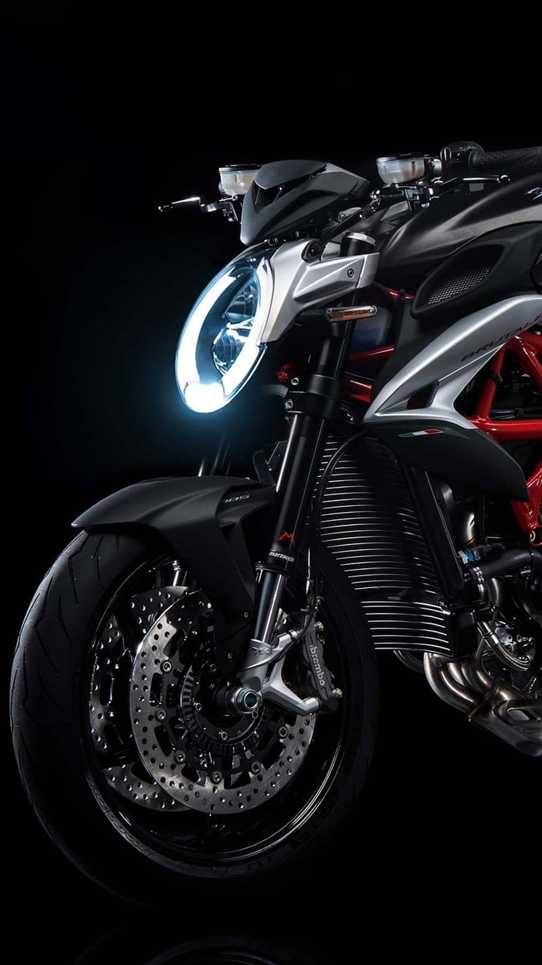 MV Agusta front assembly featuring a circular LED headlight, red frame, and black fender on a dark background.