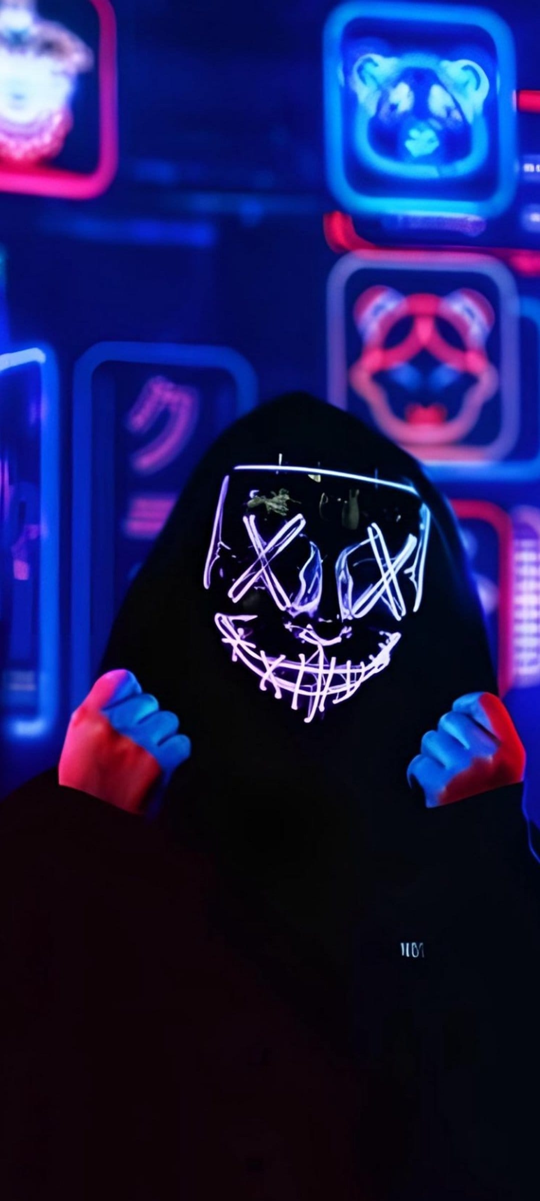Person in a glowing LED Purge mask and hoodie stands before neon panda signs and Japanese calligraphy in the dark.