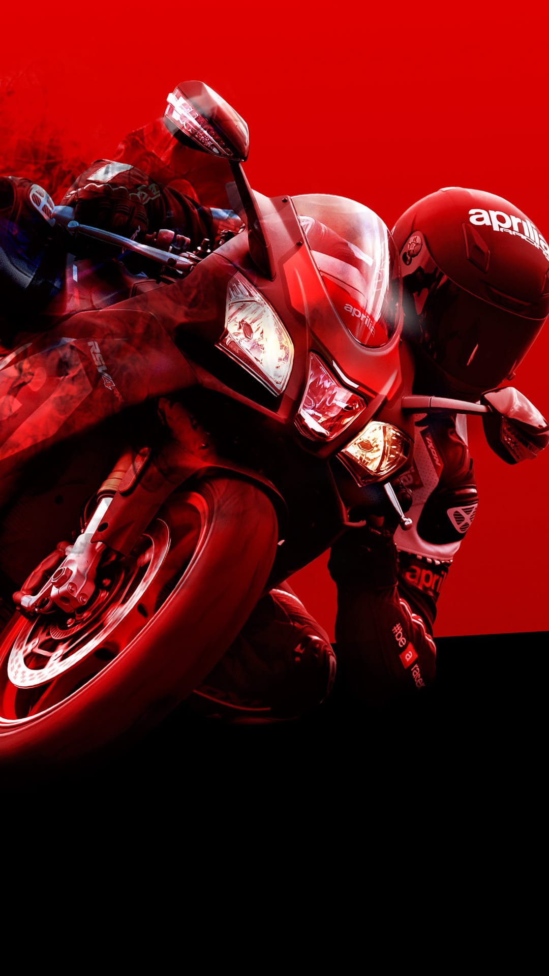 Aprilia motorcycle rider in red gear leans into a turn with smoke trailing from a sportbike's front tire.