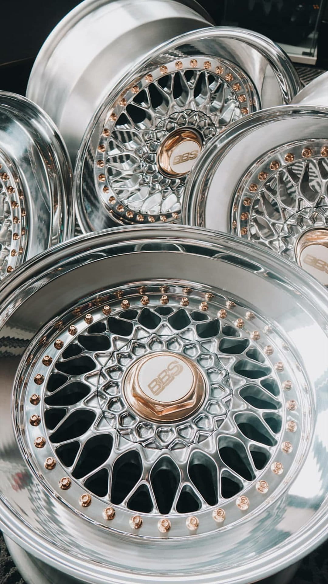 BBS RS wheels with chrome mesh spokes and gold hardware captured in a close-up vertical perspective.