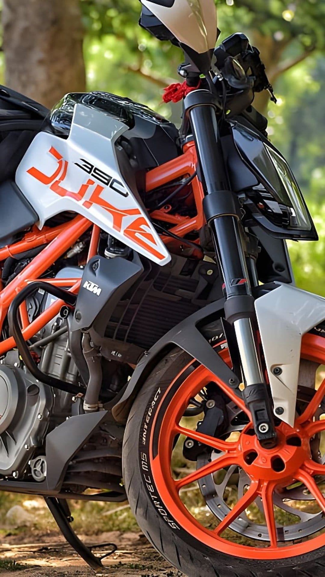 KTM 390 Duke motorcycle showing an orange trellis frame, sharp tank graphics, and a bright orange front wheel.