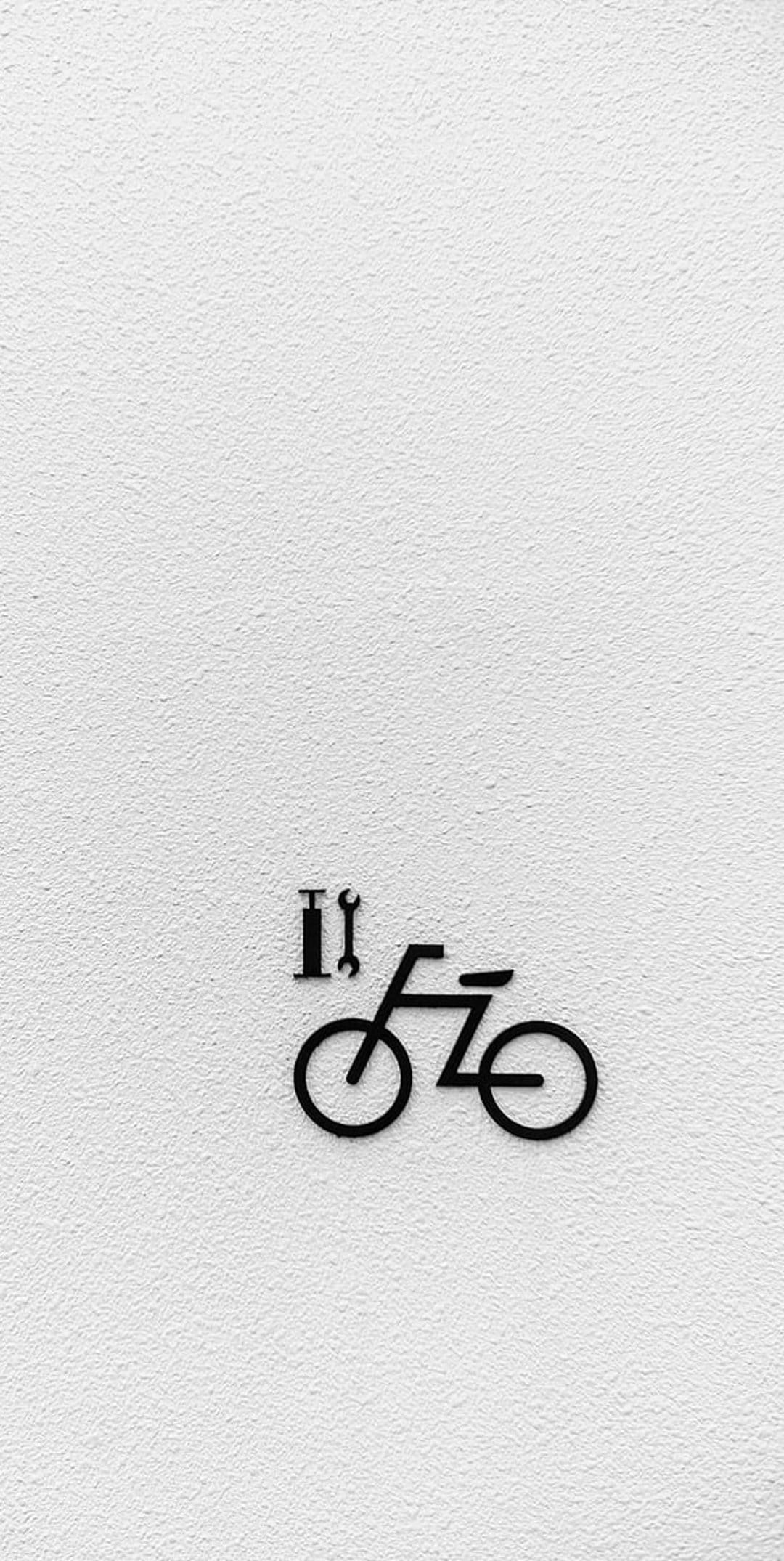 Black bicycle icon with Roman numeral two sits centered on a grainy white plaster wall with soft shadows.
