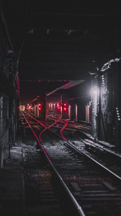 Subway, Tracks, Red lights, Urban, Dark, Gritty, Industrial, Underground, Tunnel, City, Rail, Transportation, Moody, Mystery, Depth, Perspective, Shadows, Reflection, Grime, Grate
