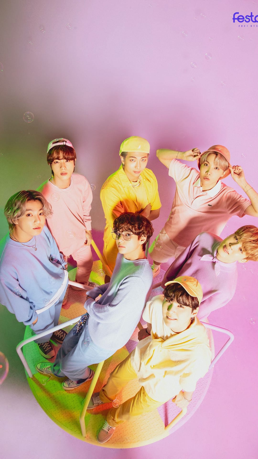 Seven BTS members in pastel suits pose playfully for a vibrant Butter era concept photo for mobile backgrounds.