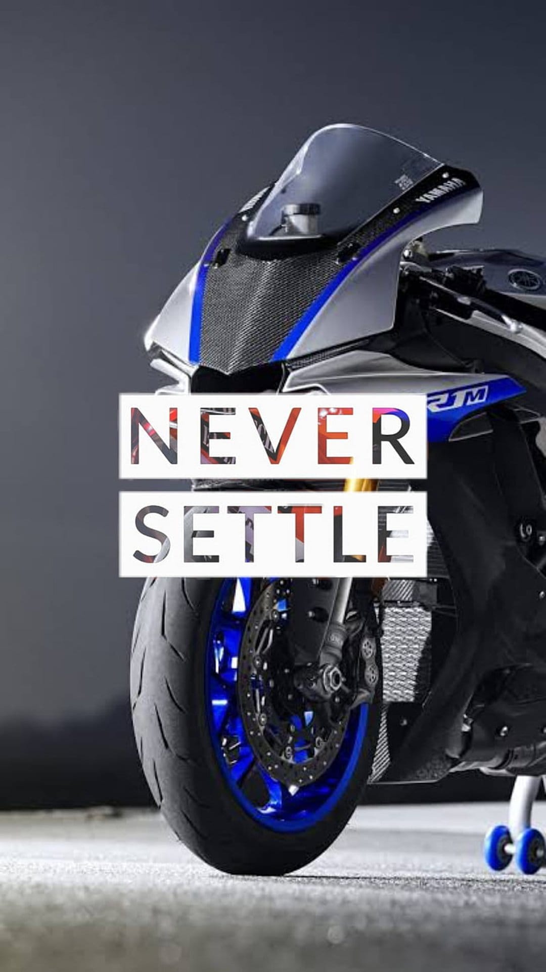 Yamaha R1 front fairing and blue wheel details with Never Settle typography against a dark background.