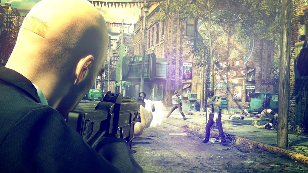 Agent 47 firing a submachine gun at police officers on a sunny, gritty city street during a combat scene.