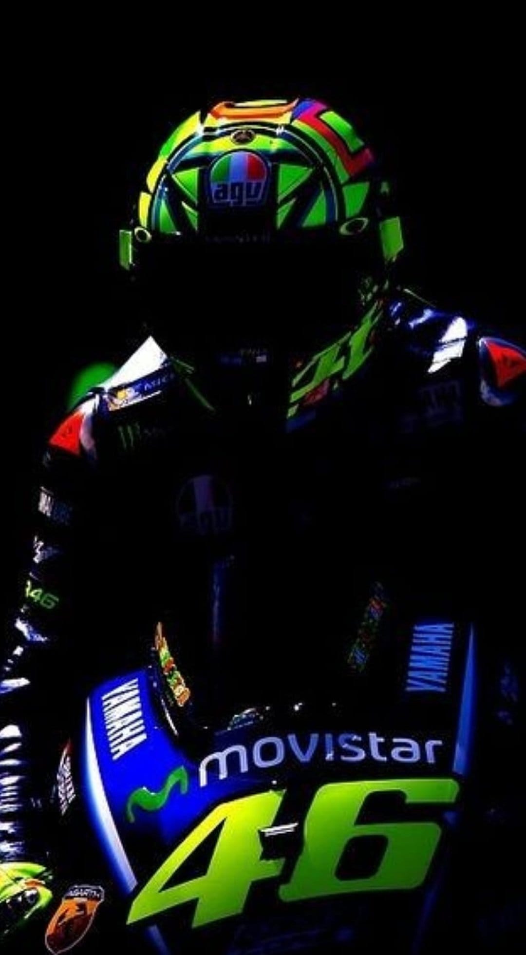 Valentino Rossi’s AGV helmet with the number 46 and Movistar Yamaha racing suit against a black background.