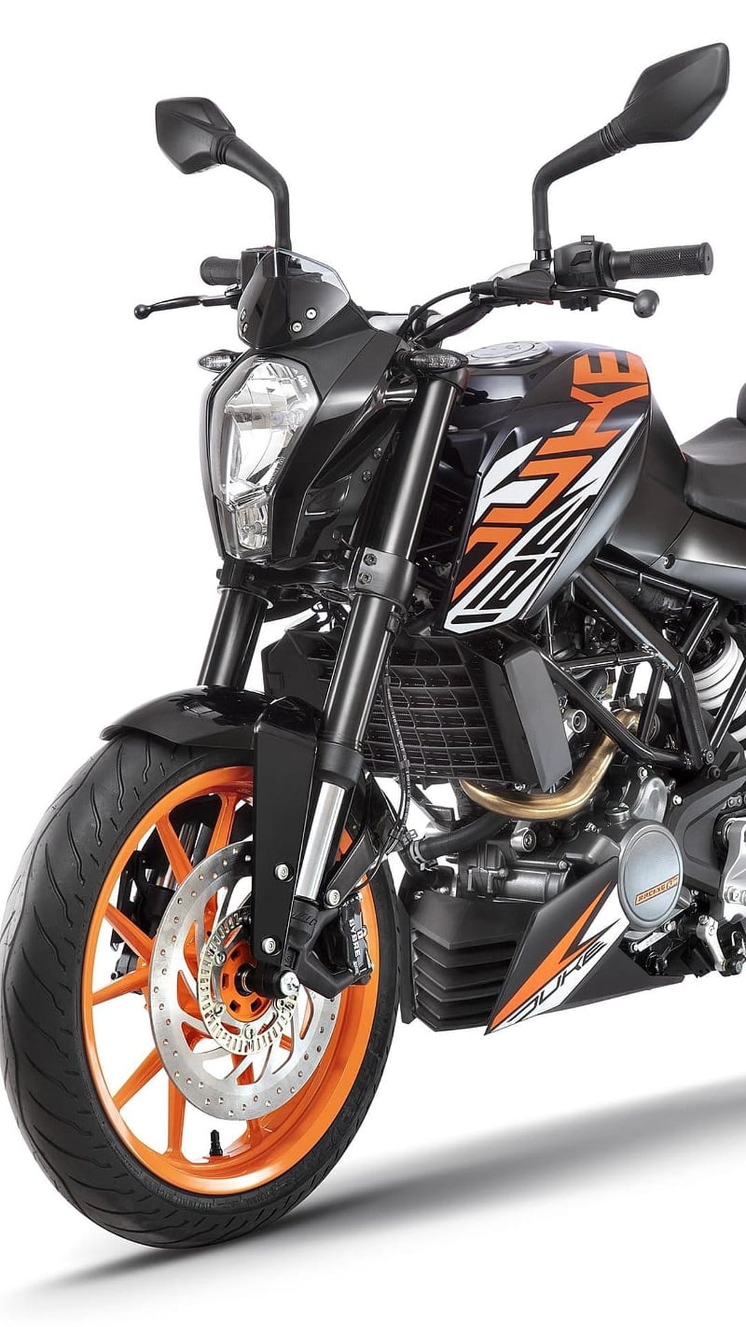 KTM 390 Duke motorcycle front view featuring a split LED headlight, orange wheels, and black streetfighter frame.