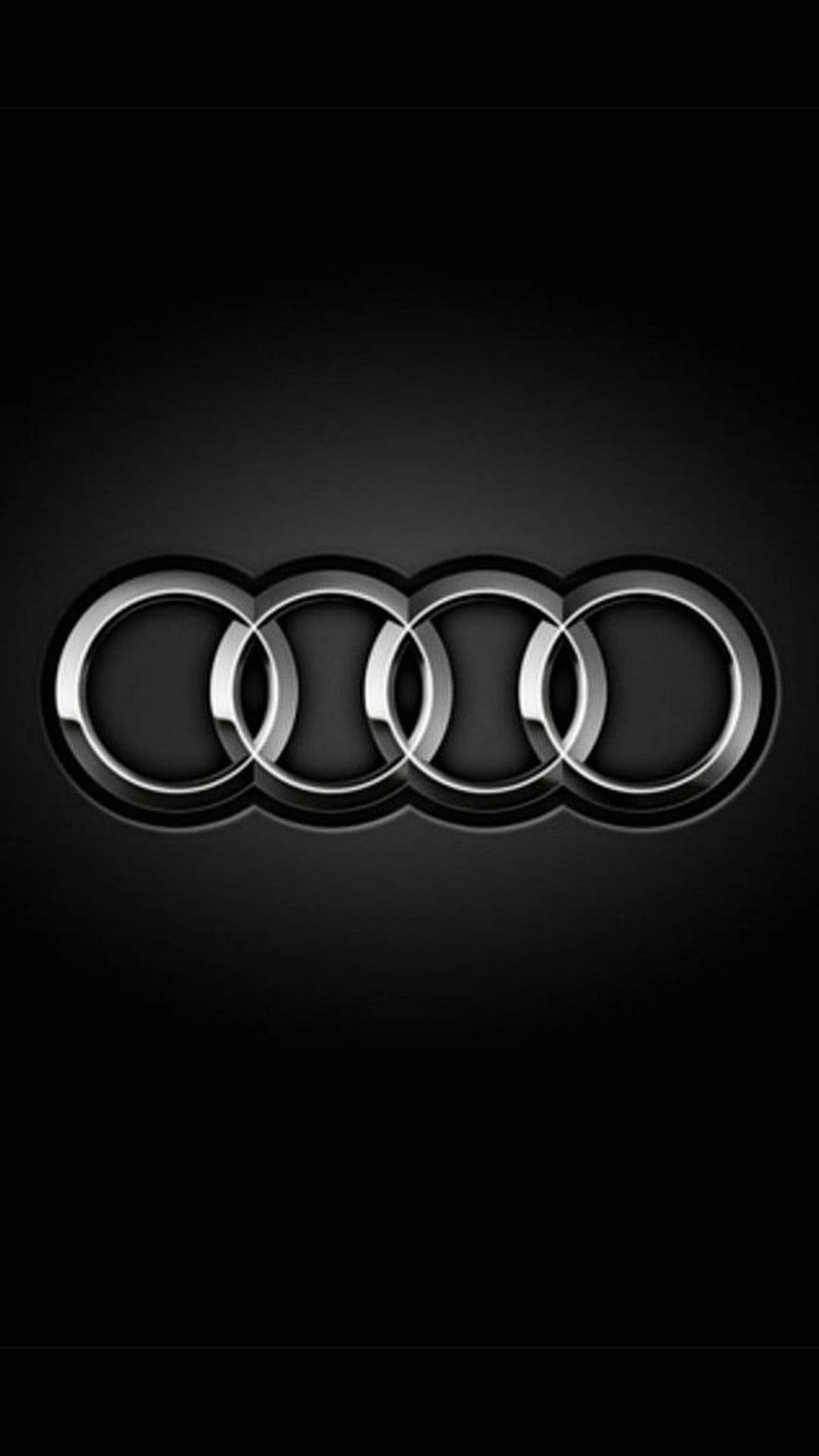 Chrome Audi rings logo with metallic reflections and 3D depth centered on a dark obsidian gradient background.