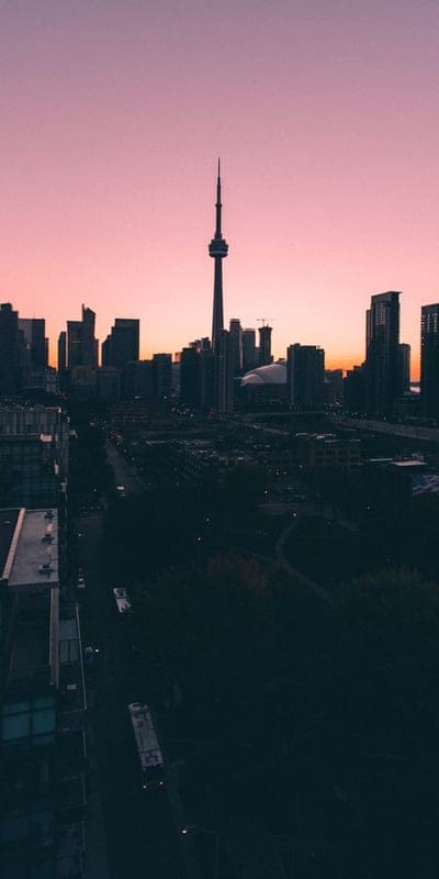 Cityscape, skyline, sunset, sunrise, urban, tower, pink sky, silhouette, dusk, dawn, architecture, modern, metropolitan, travel, destination, city lights, dramatic, peaceful, vibrant, Toronto.