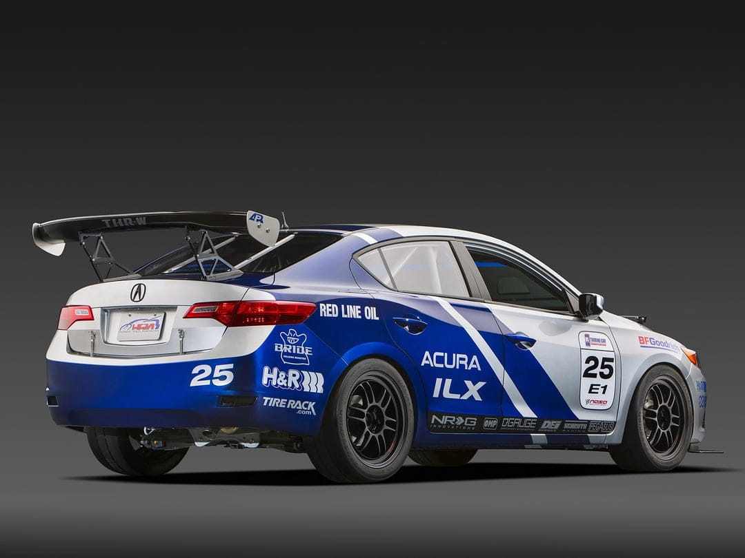 Acura ILX race car with blue and silver livery, large rear wing, and number 25 on a gray studio background.