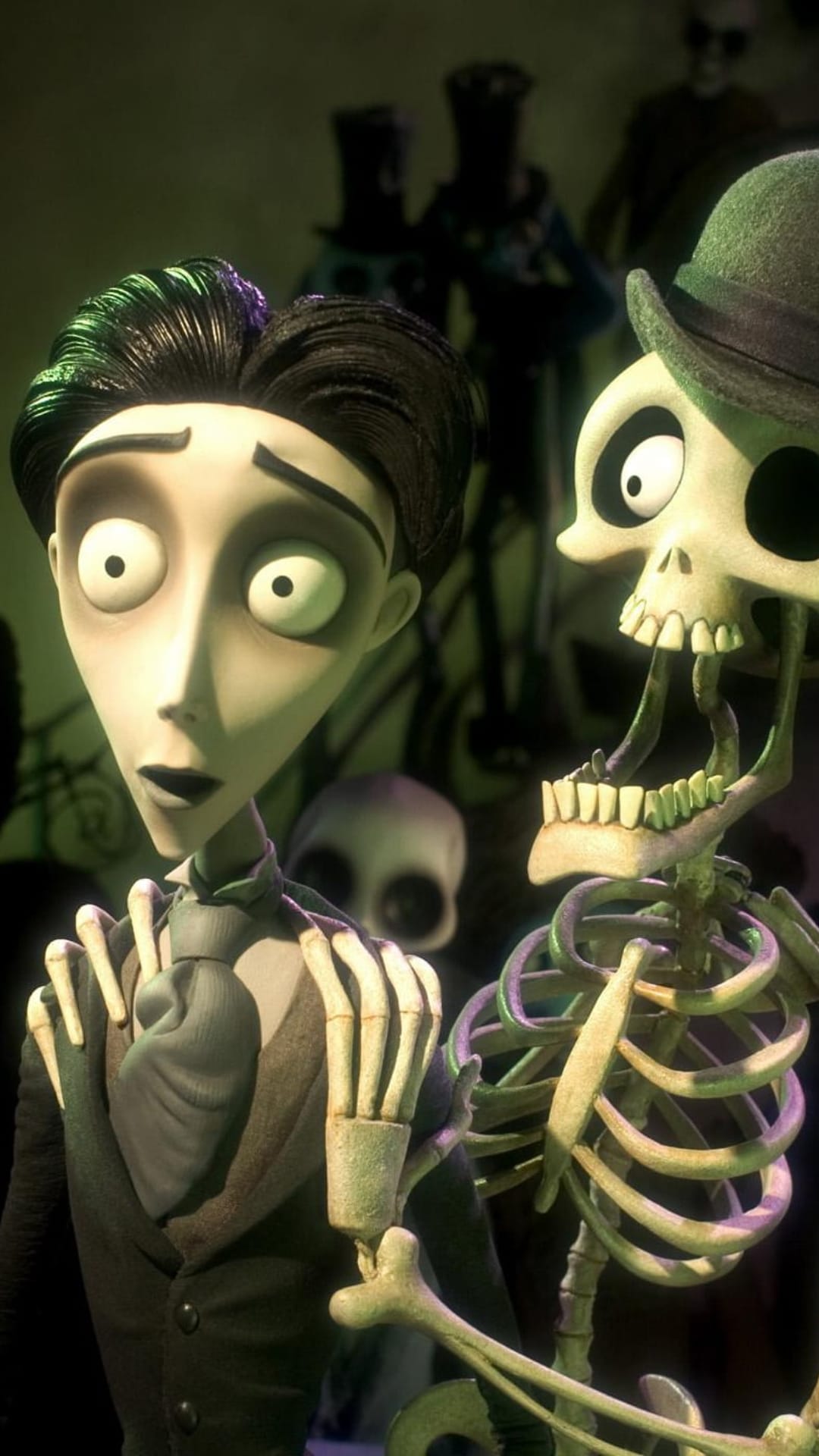 Victor Van Dort stares with wide eyes at a jovial skeleton wearing a hat with its jaw hanging wide open.