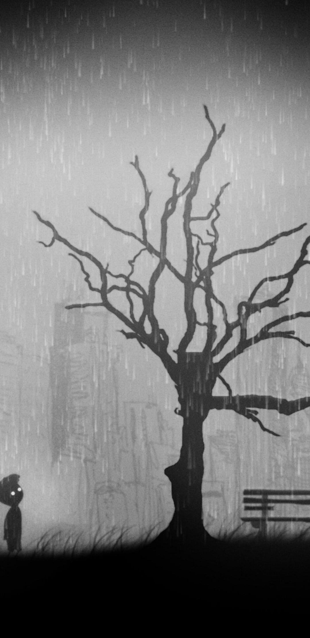 Silhouette of a small child and a leafless tree in a rainy, foggy city park with high contrast black and white.