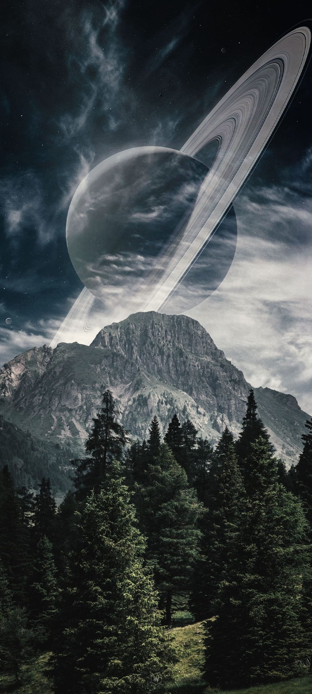 Saturn with glowing rings rises behind sharp mountain peaks and a dense evergreen forest under a cloudy sky.