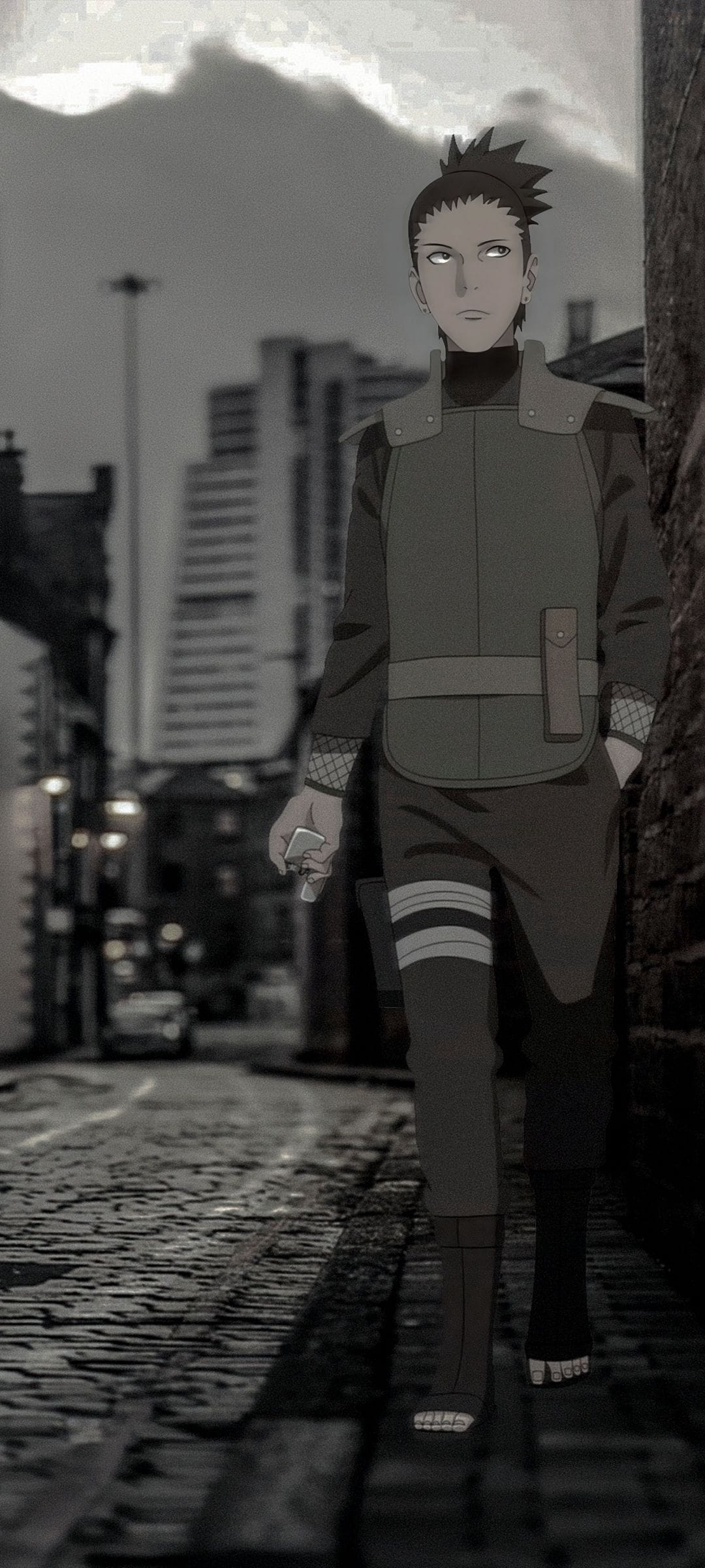 Shikamaru Nara walks down a dark cobblestone street past blurred city buildings in a monochrome urban scene.