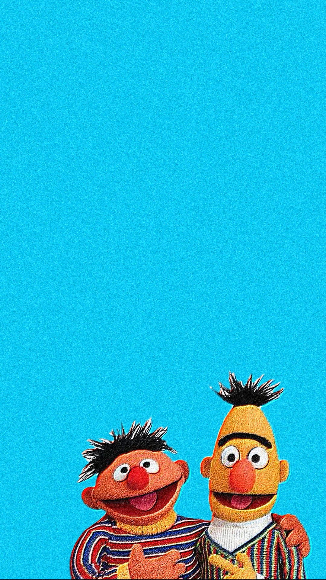 Bert and Ernie stand side-by-side in striped sweaters against a solid blue background for mobile devices.