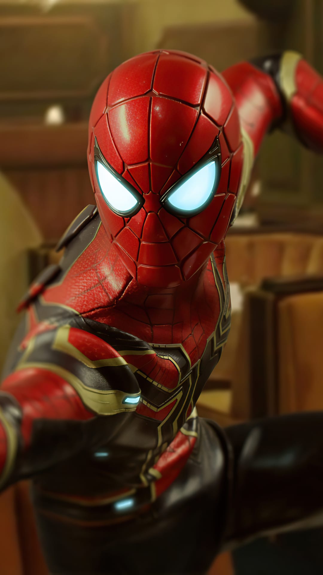 Iron Spider suit displays intricate red and gold metallic plating with glowing blue lenses and textured armor.
