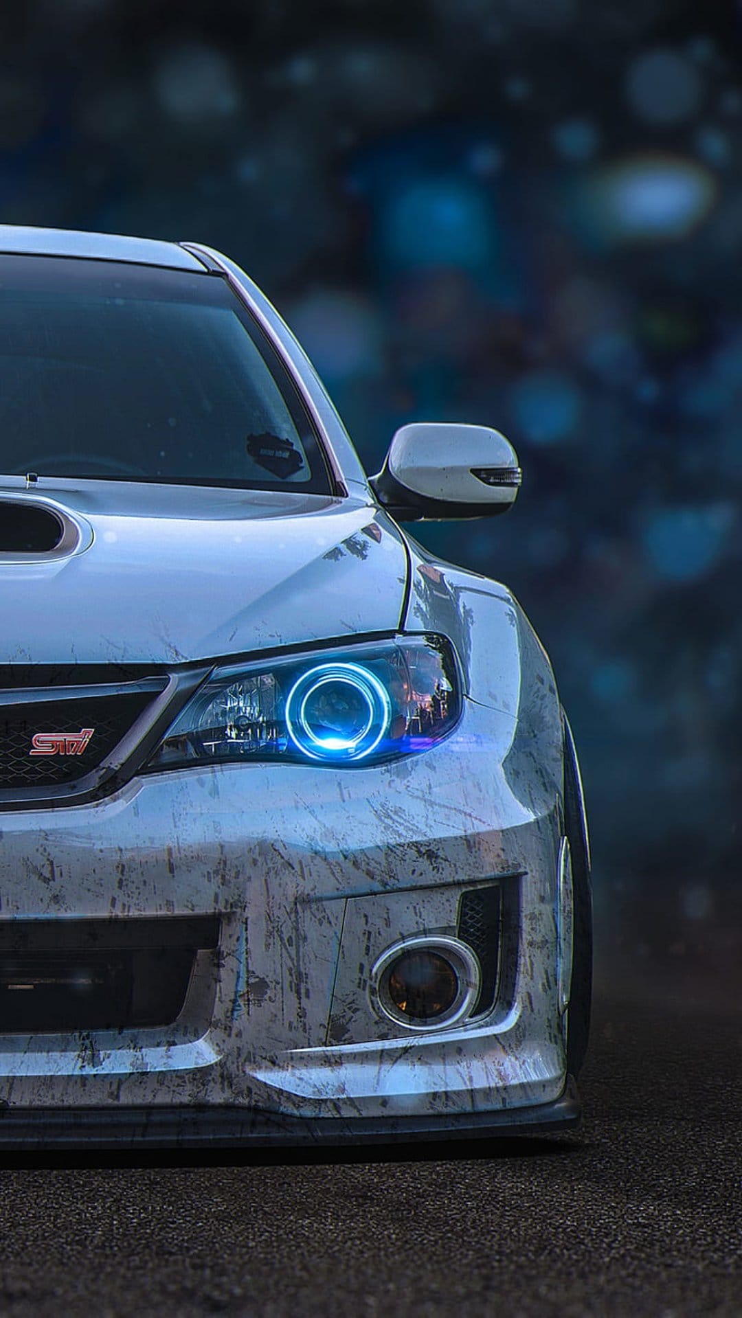 Subaru Impreza WRX STI with blue halo headlights and textured paint against a blurred urban bokeh background.