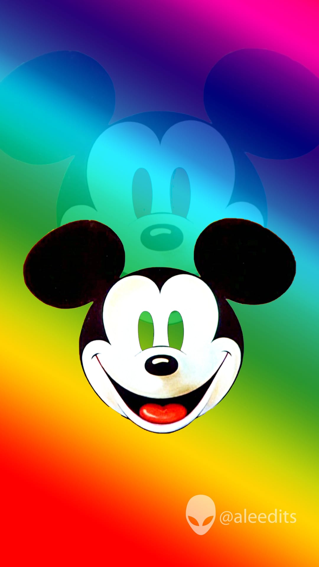 Mickey Mouse smiles in front of a vertical rainbow gradient with a small alien head icon in the bottom corner.