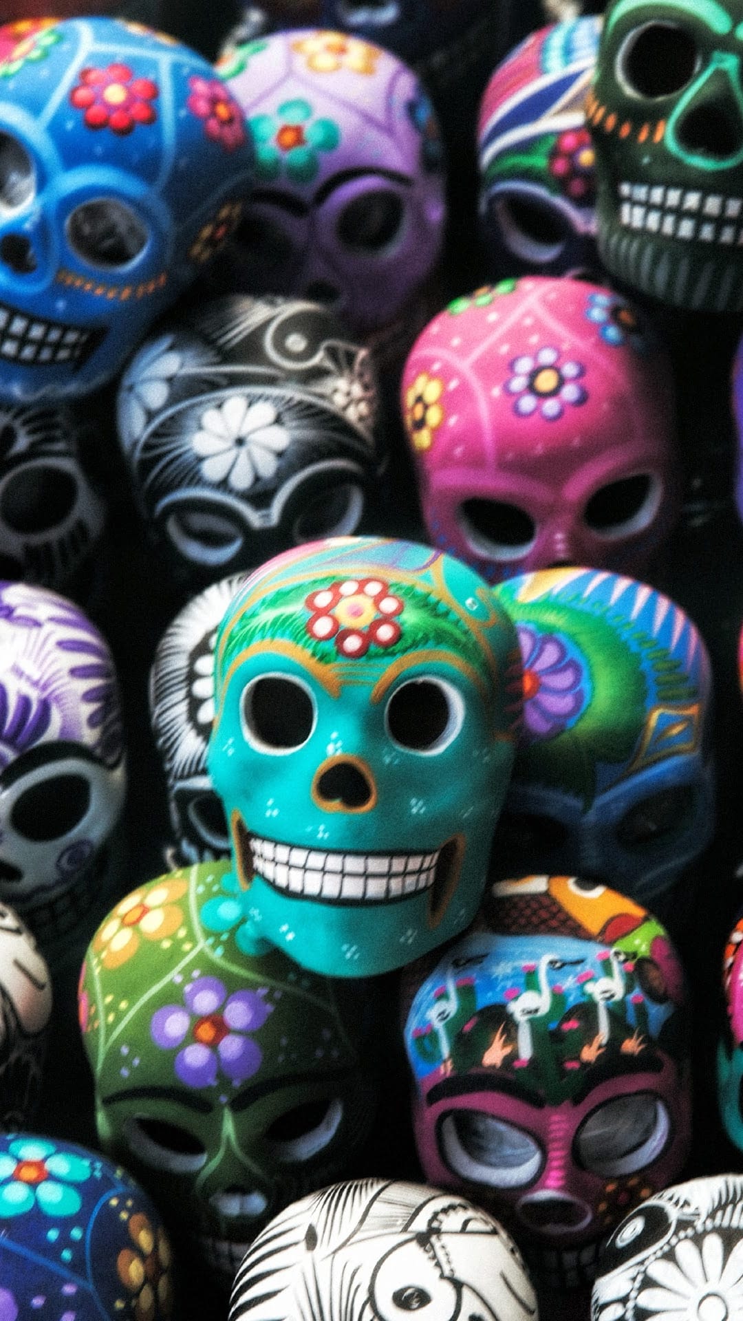 Ornate ceramic sugar skulls featuring floral motifs and vibrant hand-painted patterns for Day of the Dead.
