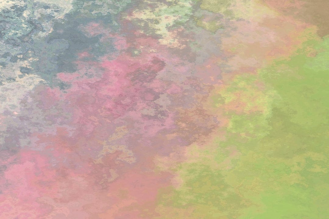 Soft pink, green, and blue watercolor paint blends across a textured surface with organic, fluid shapes.