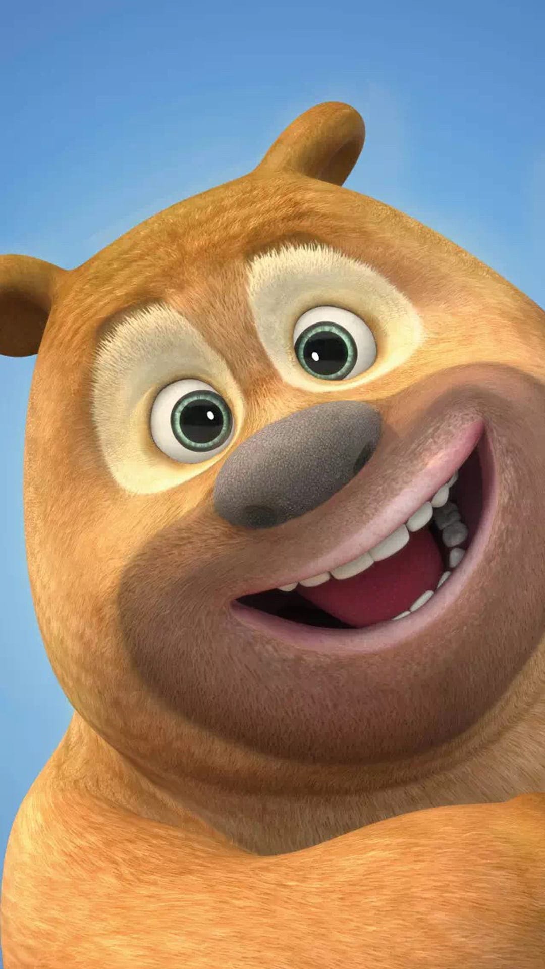 Fluffy orange bear with a wide smile and large eyes looks forward against a bright blue summer sky background.