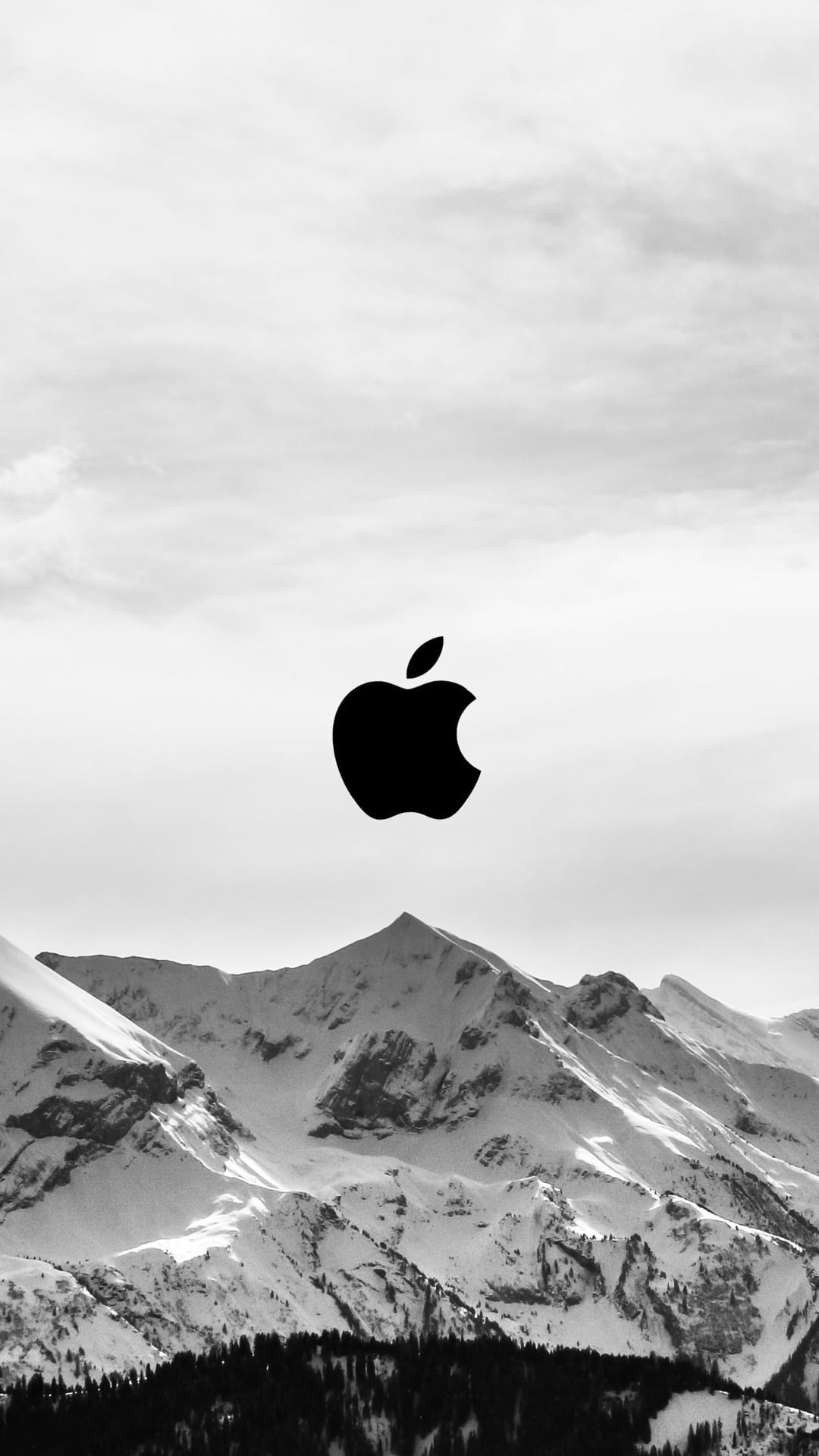 Apple logo centered above jagged snow-capped mountain peaks and dark pine forests in a monochrome landscape.