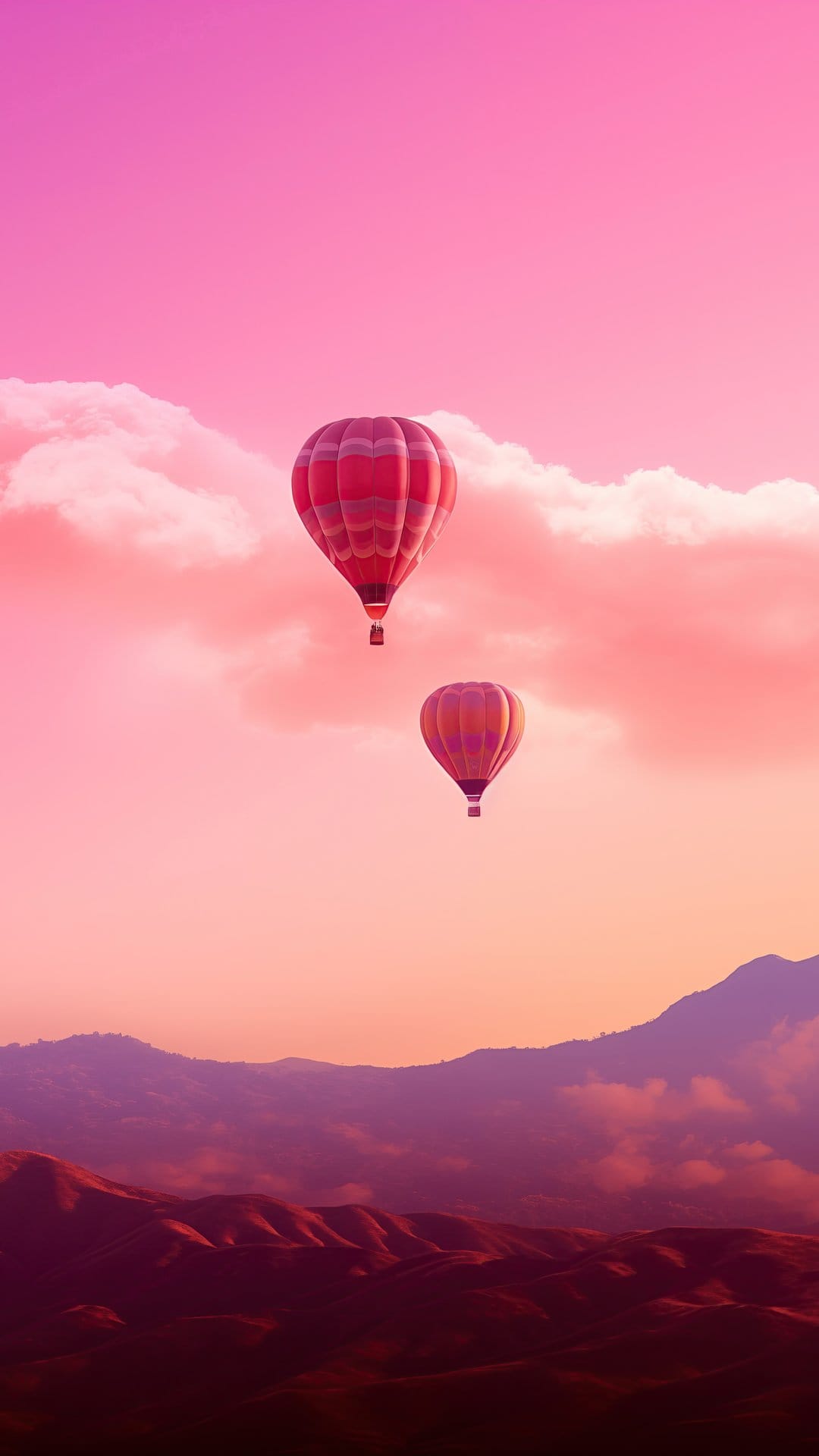 Vibrant hot air balloons drift over purple mountain peaks under a hazy pink and orange sunset sky.
