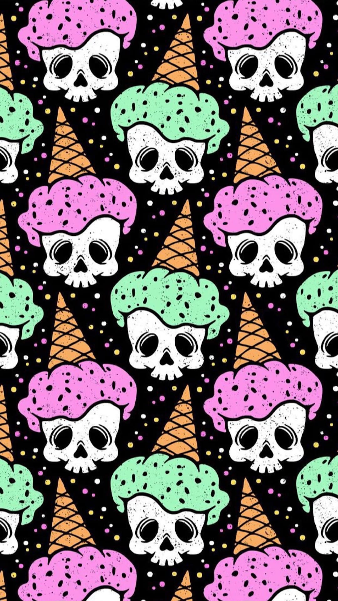 White skulls shaped like ice cream scoops on orange waffle cones with pastel pink and green toppings and confetti.