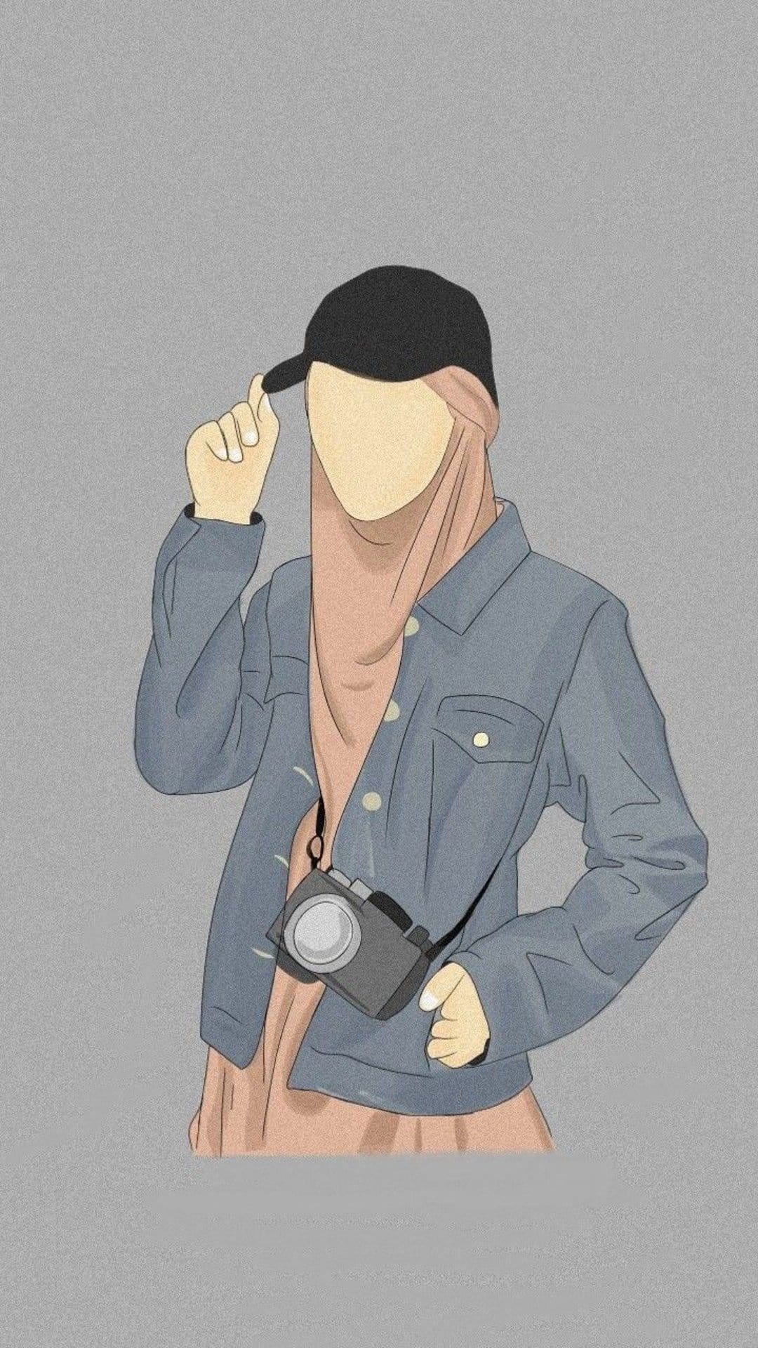 Faceless woman in a pink hijab, denim jacket, and black cap holding a camera against a textured grey backdrop.