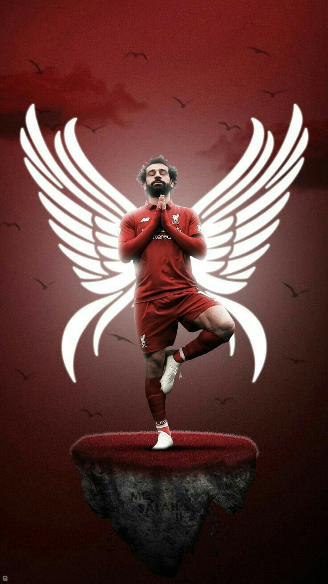 Mohamed Salah in a red kit balances on one leg with white wings against a textured crimson background.