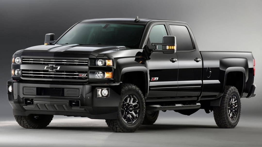 Black Chevrolet Silverado Z71 HD pickup truck with off-road tires against a grey studio background.