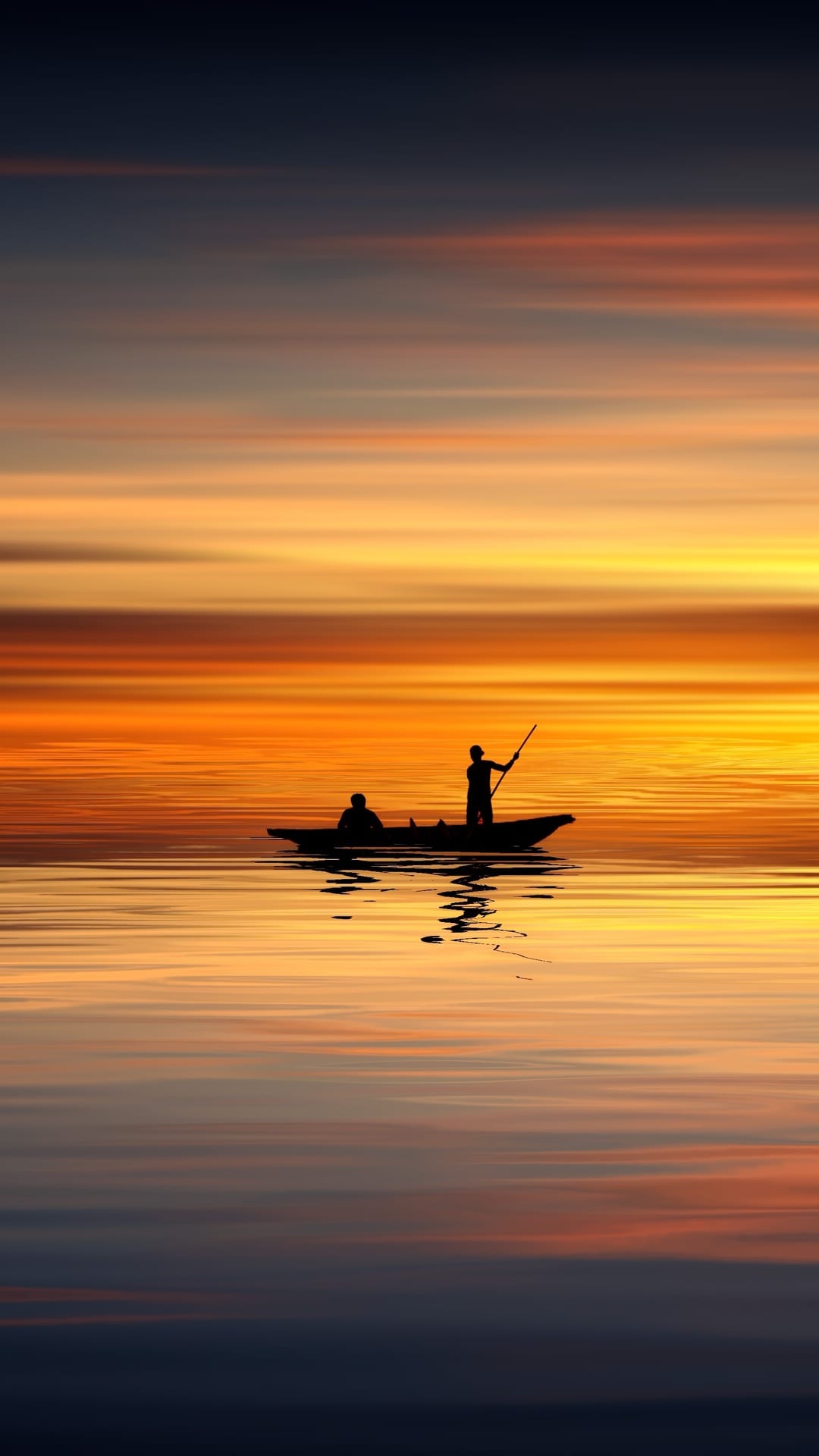 Silhouetted figures row a small boat across golden water during a vibrant orange and yellow sunset at dusk.