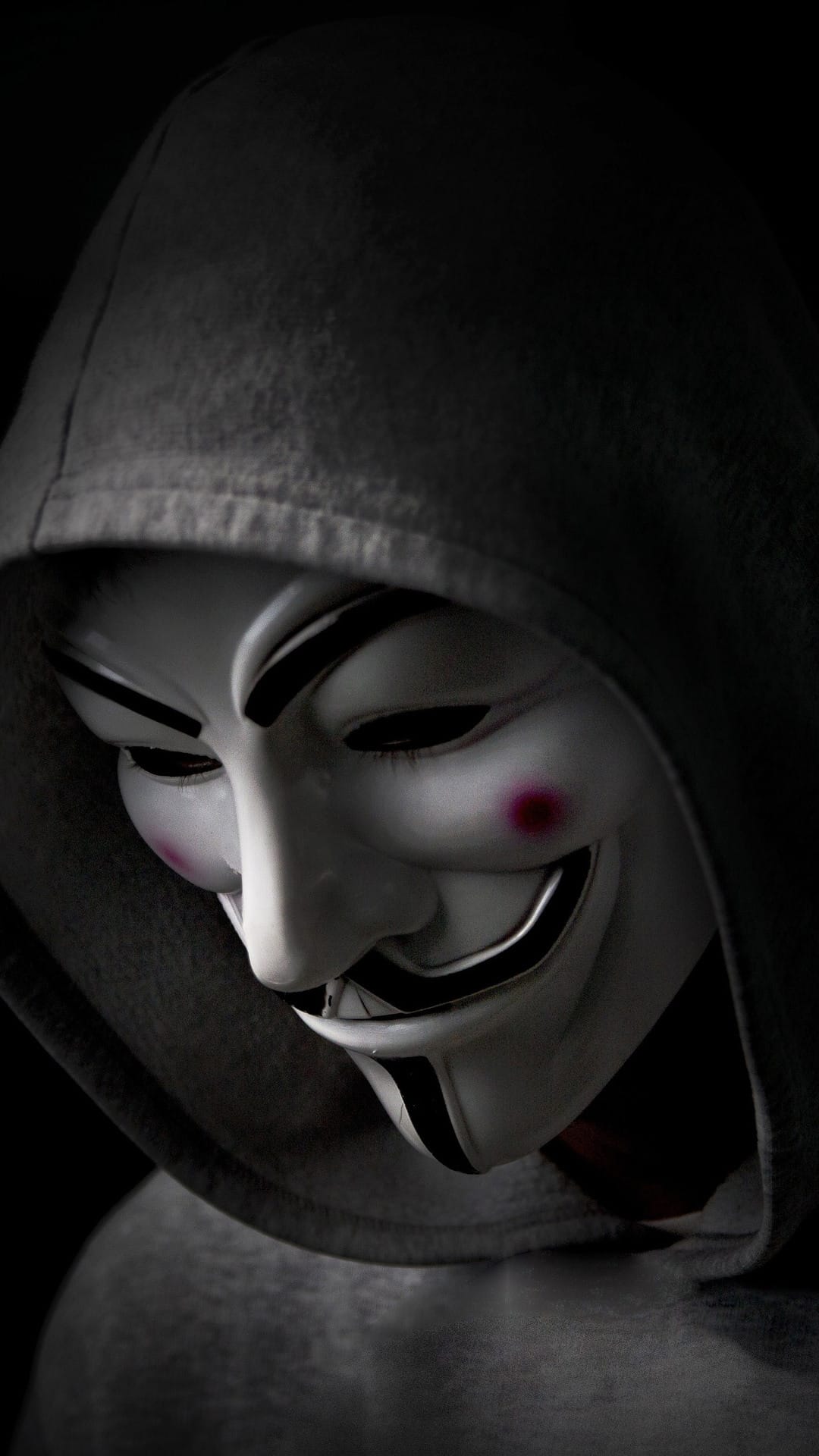 Hooded hacker figure typing amidst cascading green binary code and pixelated dinosaur icons on a dark screen.