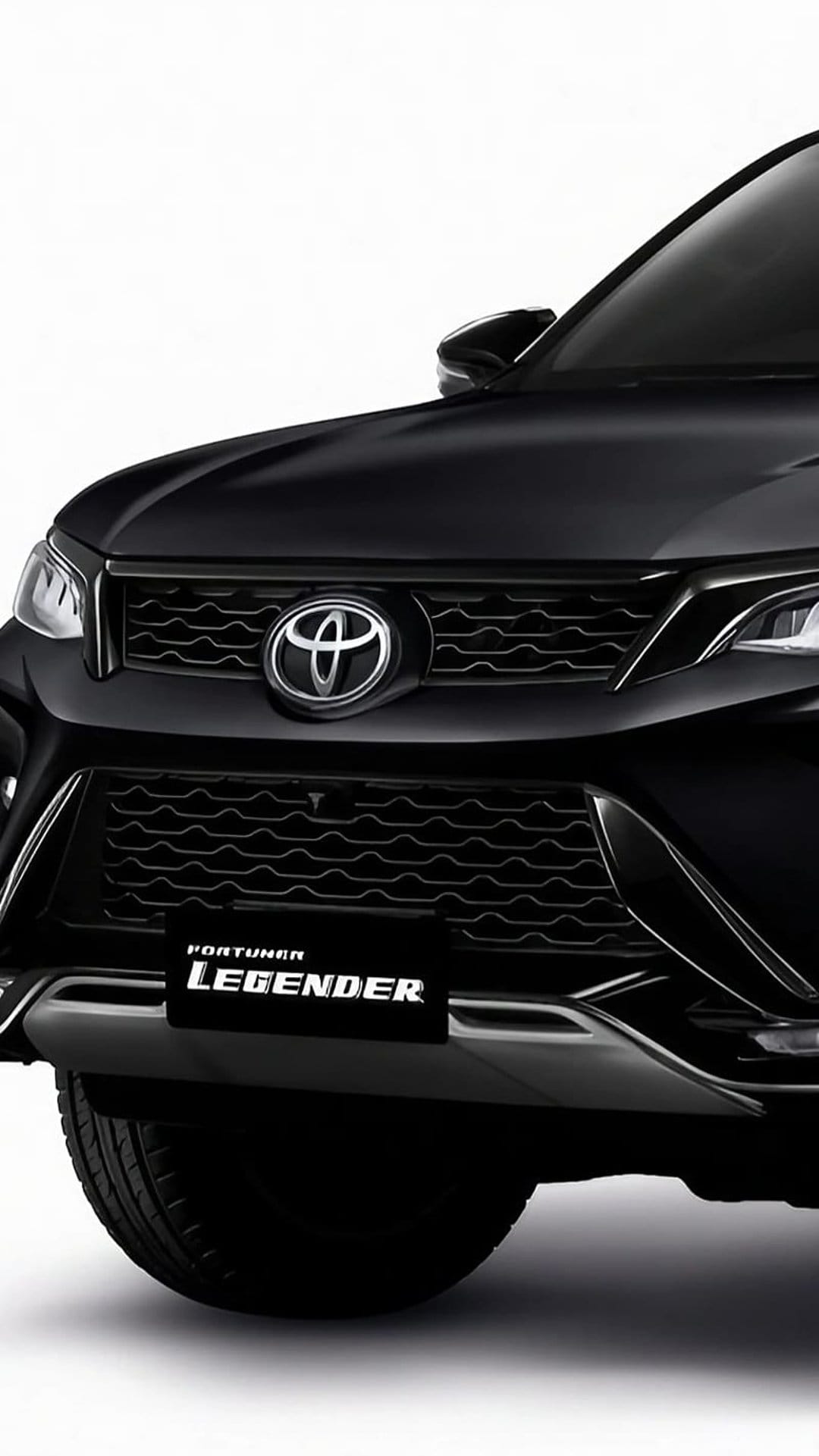 Toyota Fortuner Legender front grille and LED headlights with chrome emblem on a sleek black SUV body.