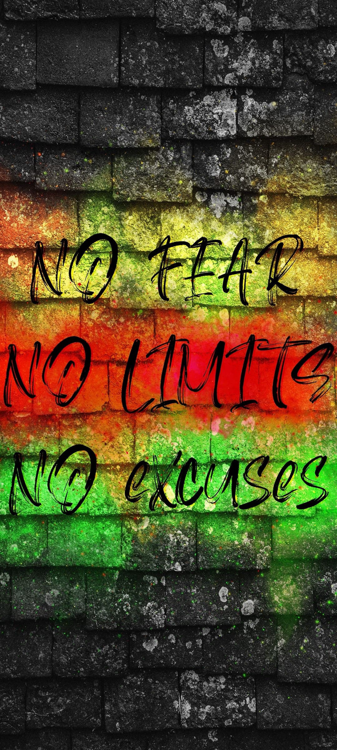 No Fear, No Limits, No Excuses text spray-painted in black over green, red, and yellow stripes on a brick wall.