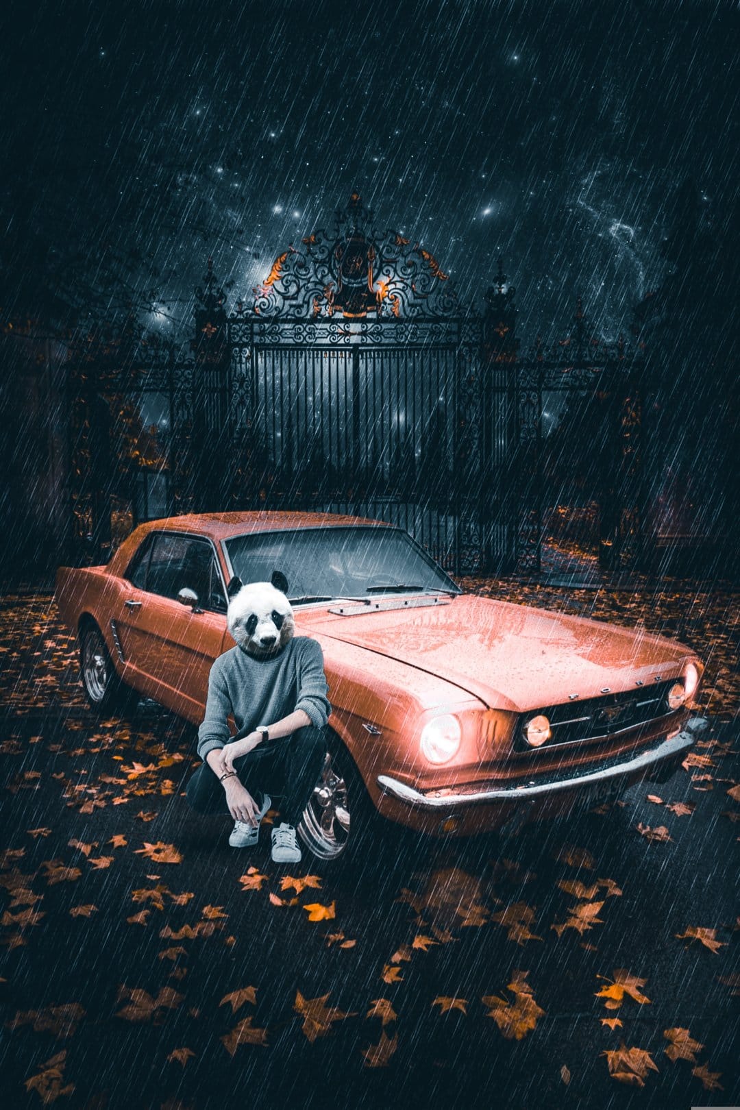 Panda-masked person crouching by a vintage orange car on a rainy night near an ornate gate with fallen leaves.