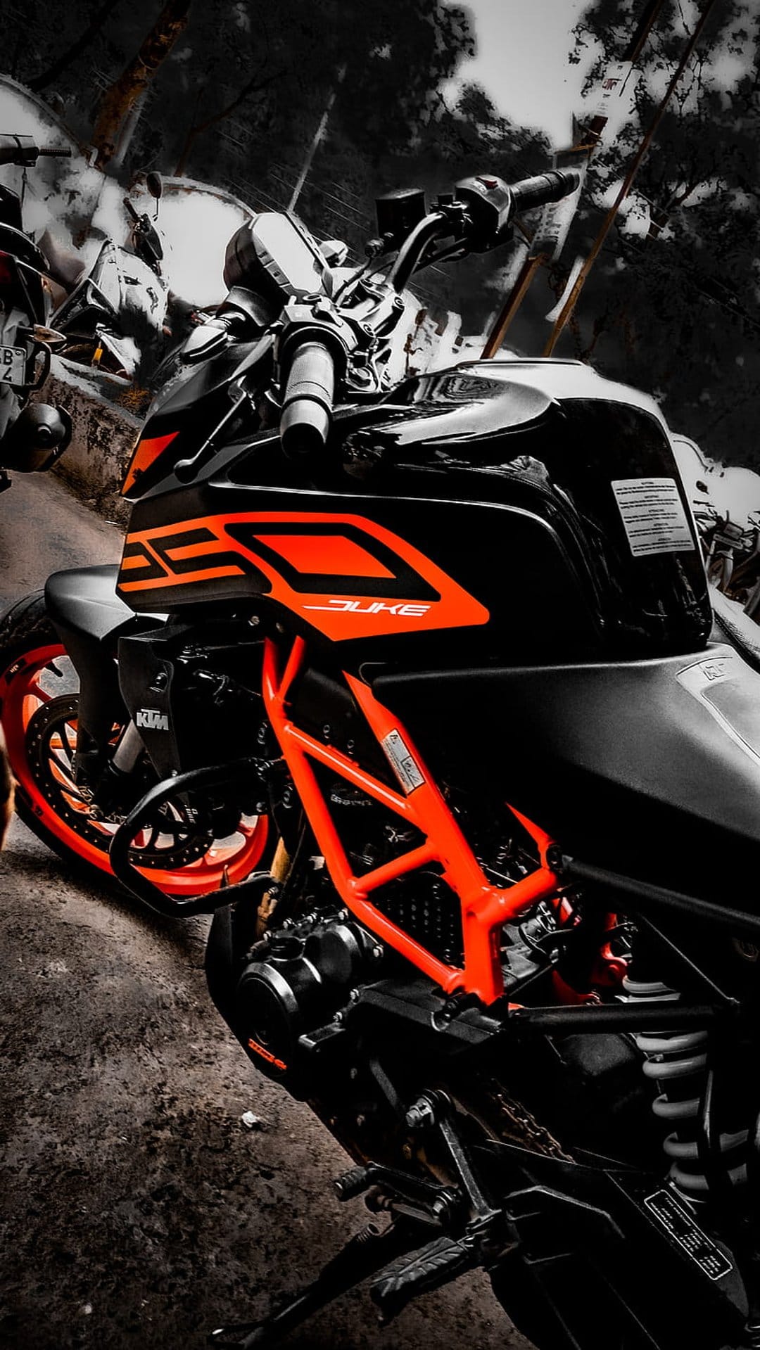 KTM Duke motorcycle featuring a bright orange trellis frame, black bodywork, and a matching orange front wheel rim.